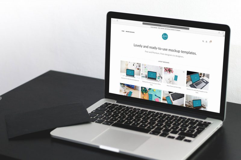 Free Macbook Pro On A Black Table Mockup