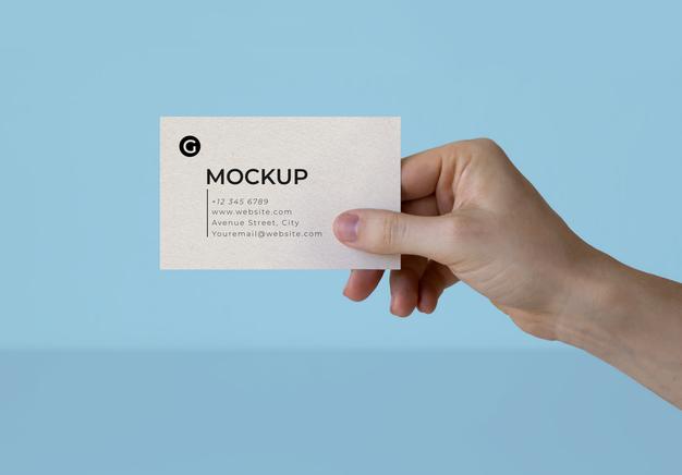 Free A Hand Holding A Business Card Mockup Psd