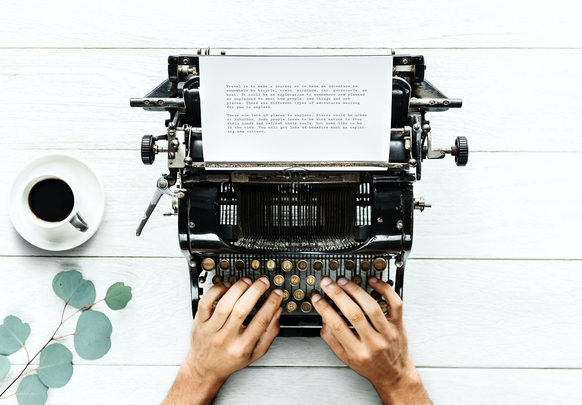 Free Aerial View Of A Man Typing On A Retro Typewriter
