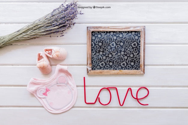 Free Baby Mockup With Slate And Pink Bib Psd