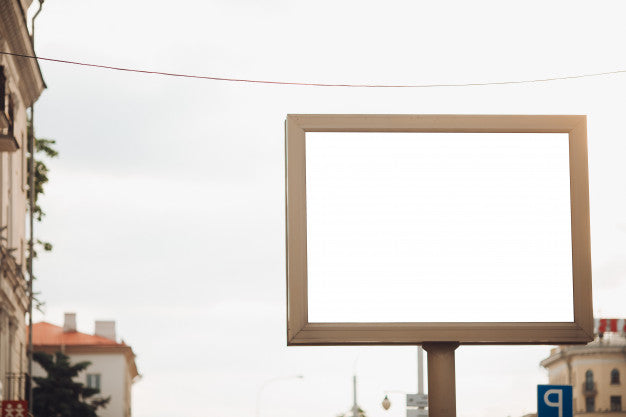 Free Bilbard With Multi-Colored Advertising And Illumination Stands On The Street In Daylight, Photo Below Psd