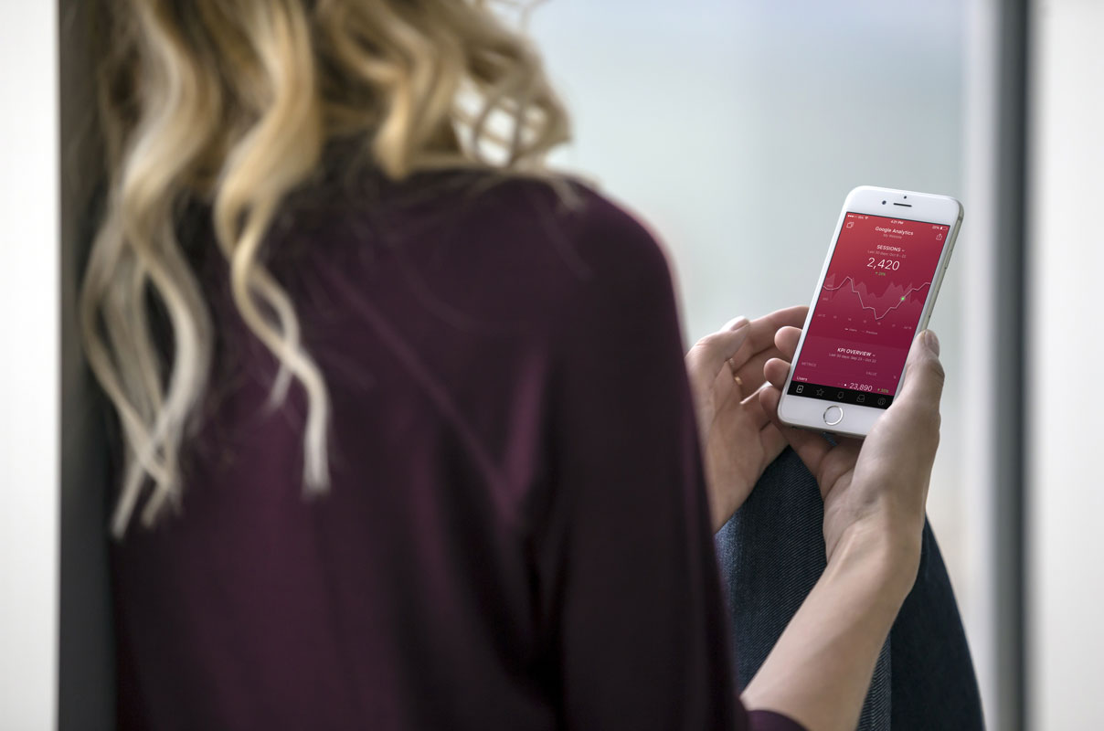 Free Blond Woman Holding a White iPhone 7 PSD Mockups