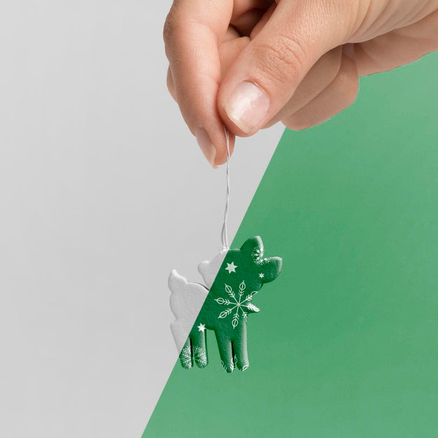Free Close-Up Hand Holding Reindeer Decoration Psd