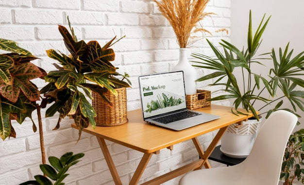 Free Close Up On Computer Mockup Surrounded By Plants Psd