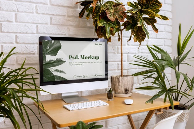 Free Close Up On Computer Mockup Surrounded By Plants Psd