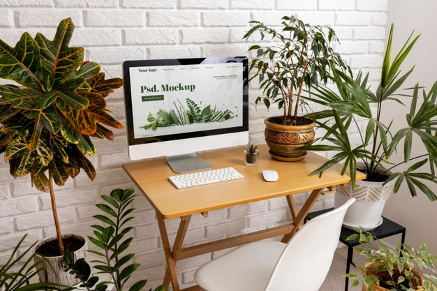 Free Close Up On Computer Mockup Surrounded By Plants Psd