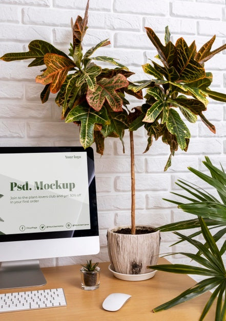 Free Close Up On Computer Mockup Surrounded By Plants Psd