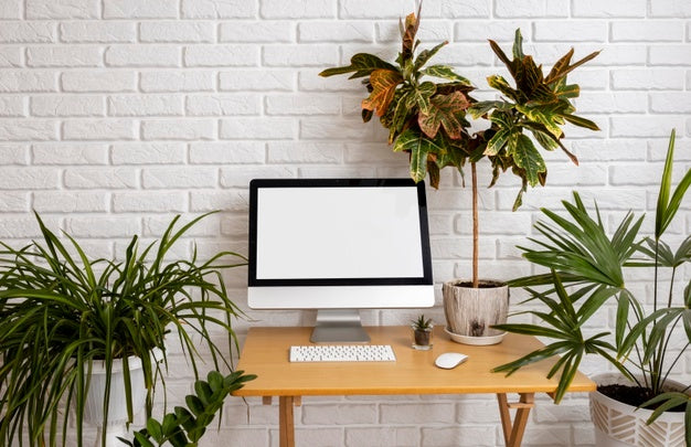 Free Close Up On Computer Mockup Surrounded By Plants Psd