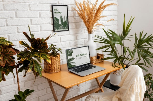 Free Close Up On Computer Mockup Surrounded By Plants Psd