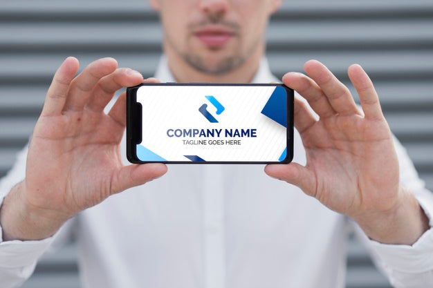 Free Elegant Business Man Holding Phone Mock-Up Psd