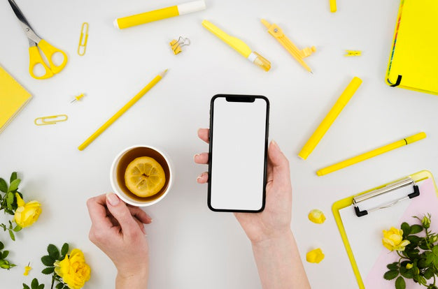 Free Flat Lay Hands Holding Smartphone Mock-Up With Stationery Psd