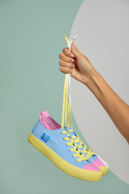 Free Front View Of Hand Held Sneakers Psd