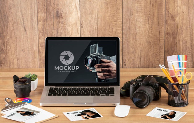 Free Front View Of Photographer Wooden Workspace With Laptop Psd