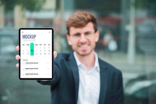 Free Front View Of Smiley Businessman Holding Tablet Psd