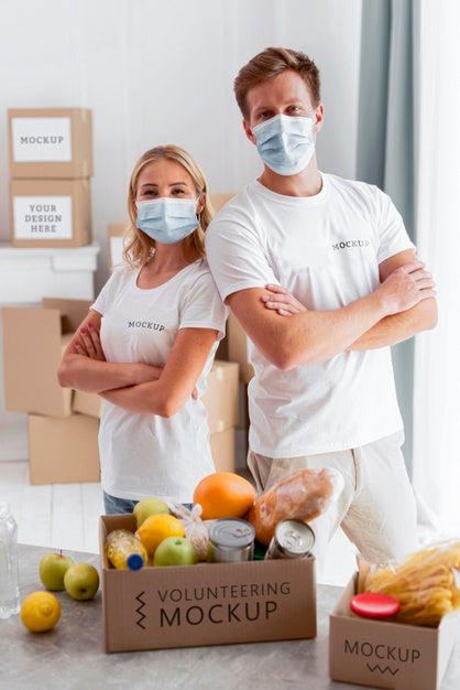 Free Front View Of Volunteers With Medical Masks Posing With Donation Boxes Psd