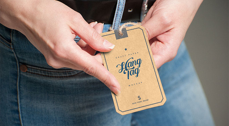 Free Hand Holding Kraft Paper Hang Tag Mockup Psd