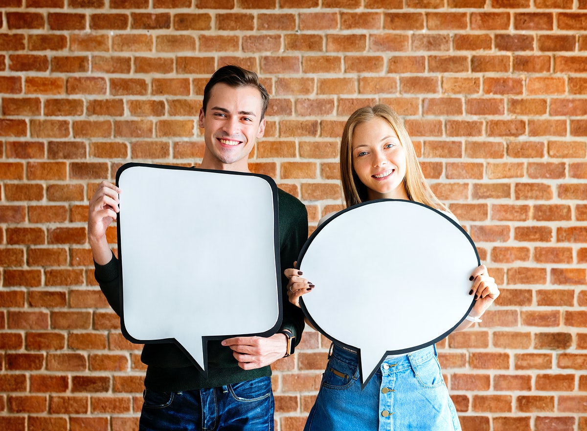 Free Happy Cute Young Couple Holding An Empty Placard Thought Bubble Copyspace