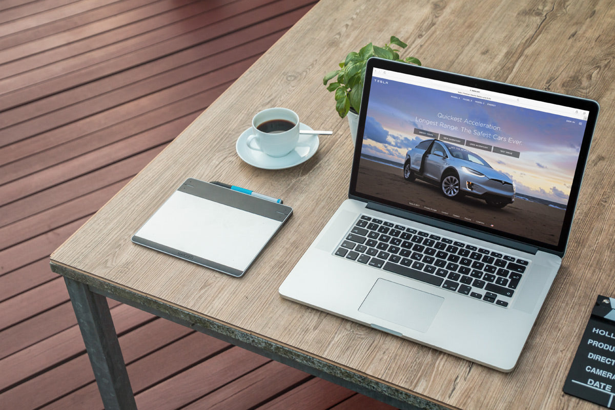 Free Macbook Next To Morning Coffee Cup Mockup Scene