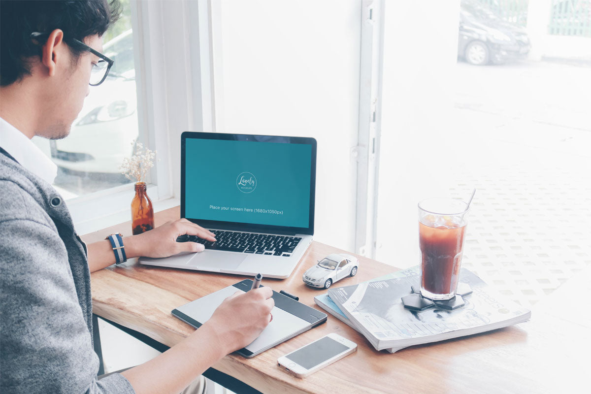 Free Man Working on a Macbook Pro Mockup