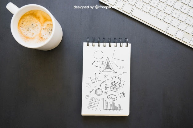Free Notebook With Drawings, Coffee Mug And Keyboard Psd