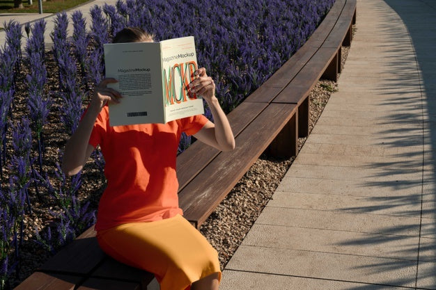 Free Person Reading Color Pop Magazine With Cover Mockup Psd