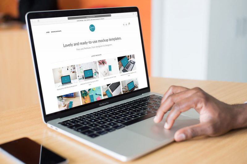 Free Mockup Of A Person Working On Macbook Pro