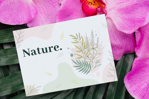 Free Positive Message On Card Beside Flowers Psd