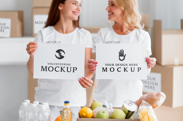 Free Smiley Female Volunteers Holding Blank Papers Next To Food Box Psd