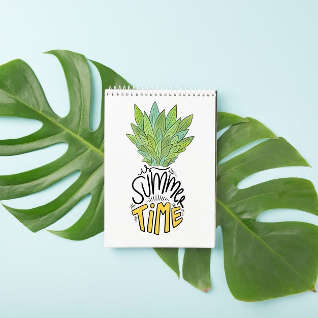 Free Spiral Notepad Mockup On Palm Leaf Psd