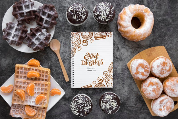 Free Top View Of Assortment Of Desserts With Fruit And Notebook Psd