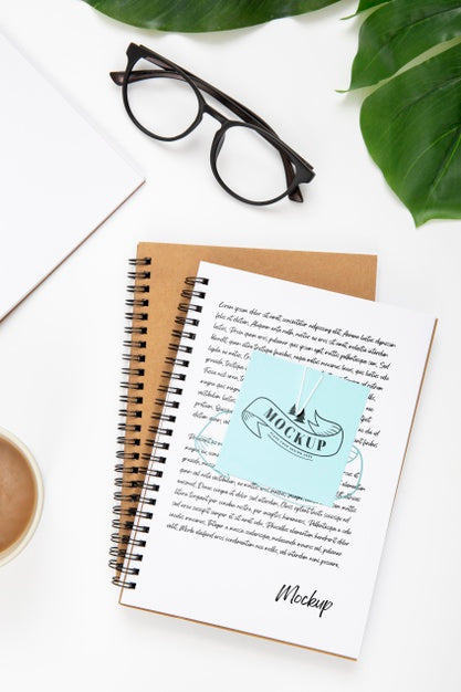 Free Top View Of Desk Surface With Notebooks And Leaves Psd