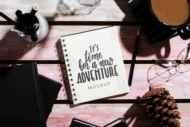 Free Top View Of Notebook On Desk With Pine Cone And Coffee Psd
