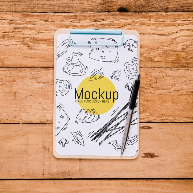 Free Top View Of Notepad With Pen And Cheese Design Psd