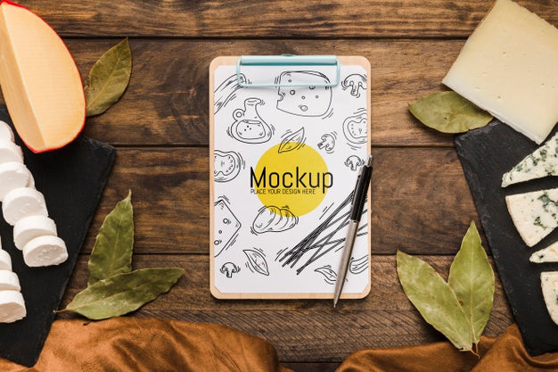 Free Top View Of Notepad With Pen And Variety Of Cheese Psd