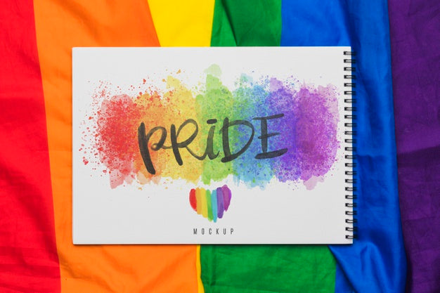 Free Top View Of Rainbow Colored Textile With Notebook Psd