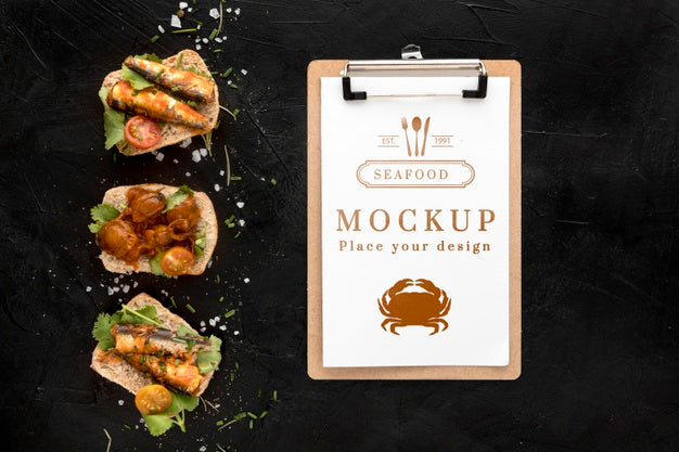 Free Top View Of Seafood Dishes With Notepad Psd