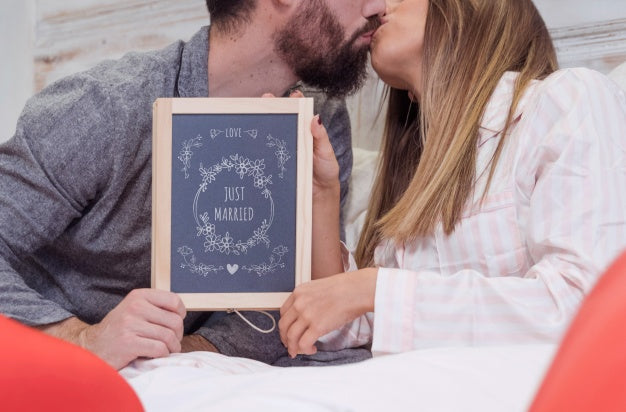 Free Valentine Mockup With Couple In Bed Showing Slate Psd