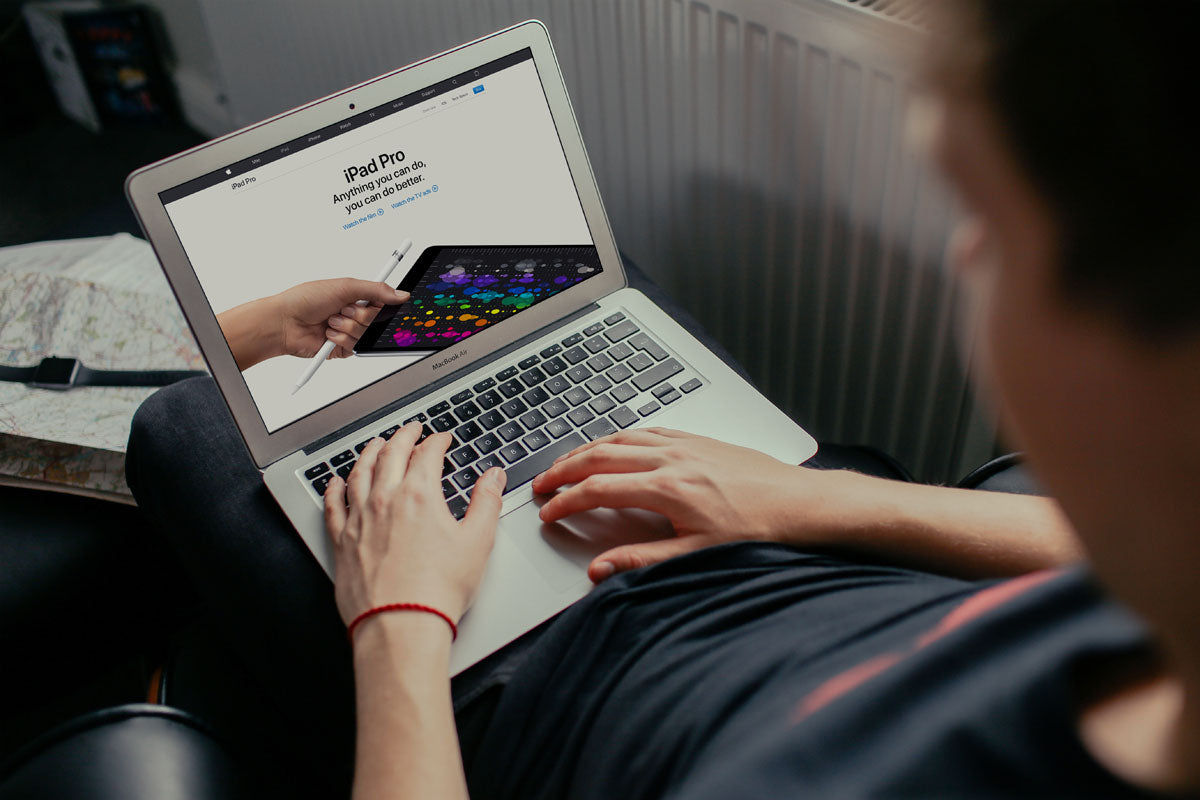 Free Young Man Working on his Macbook Air Mockup