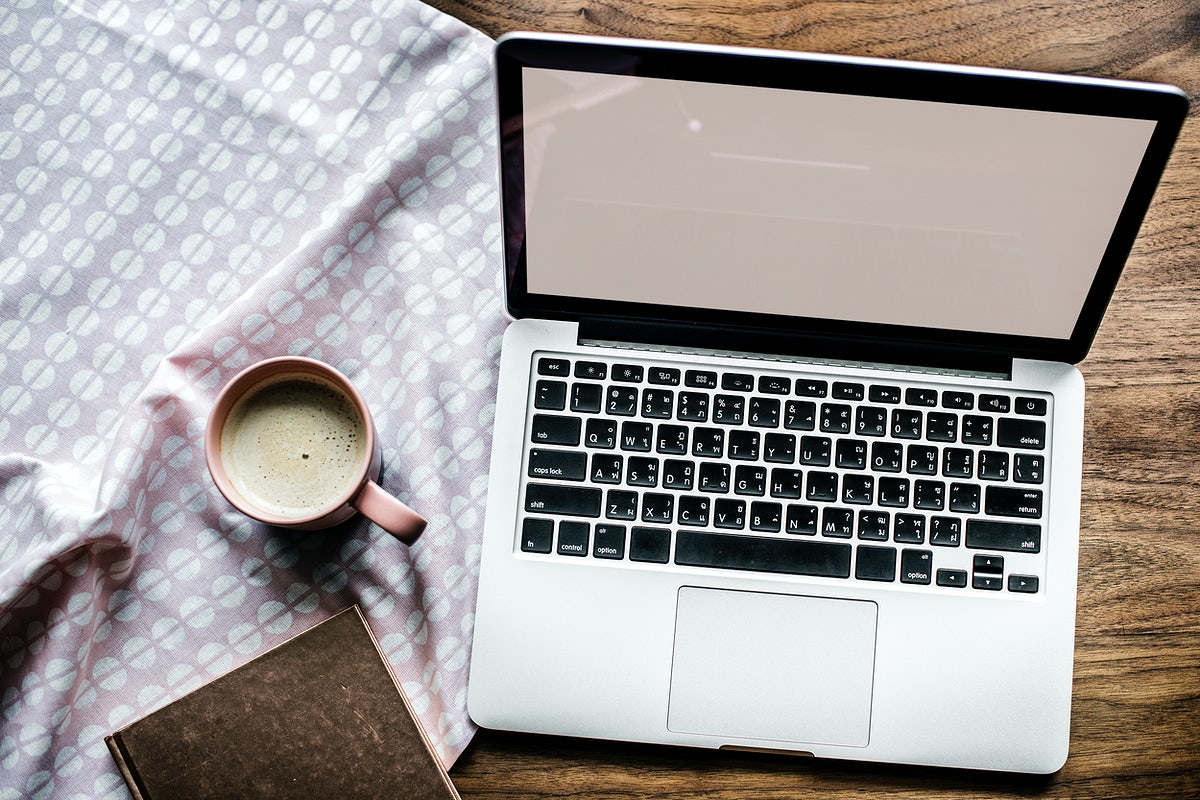 Free Aerial View Of Computer Laptop On Wooden Table And A Cup Of Hot Milk