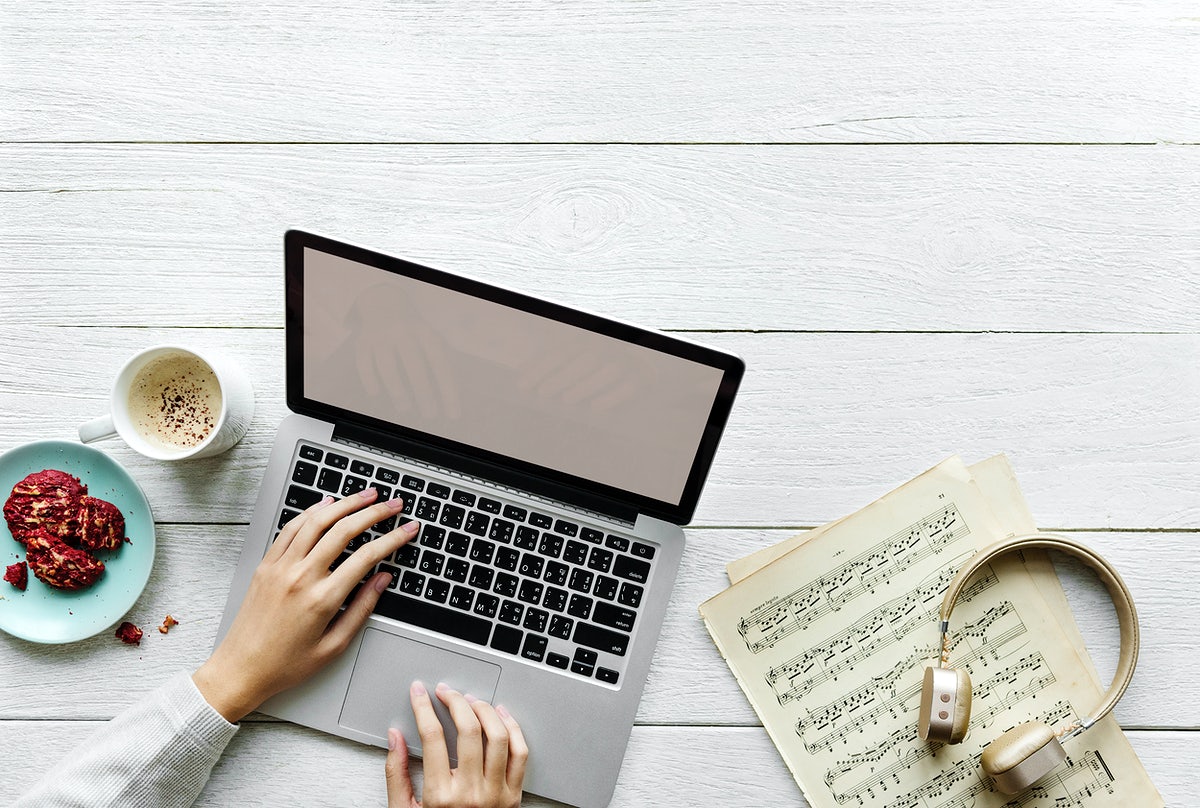 Free Aerial View Of Woman Using A Computer Laptop On Wooden Table Music Workspace Concept