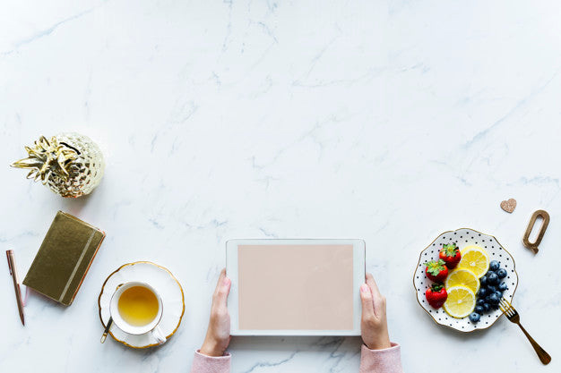 Free Aerial View Of Woman Using A Digital Tablet On A Marble Table With Design Space Psd