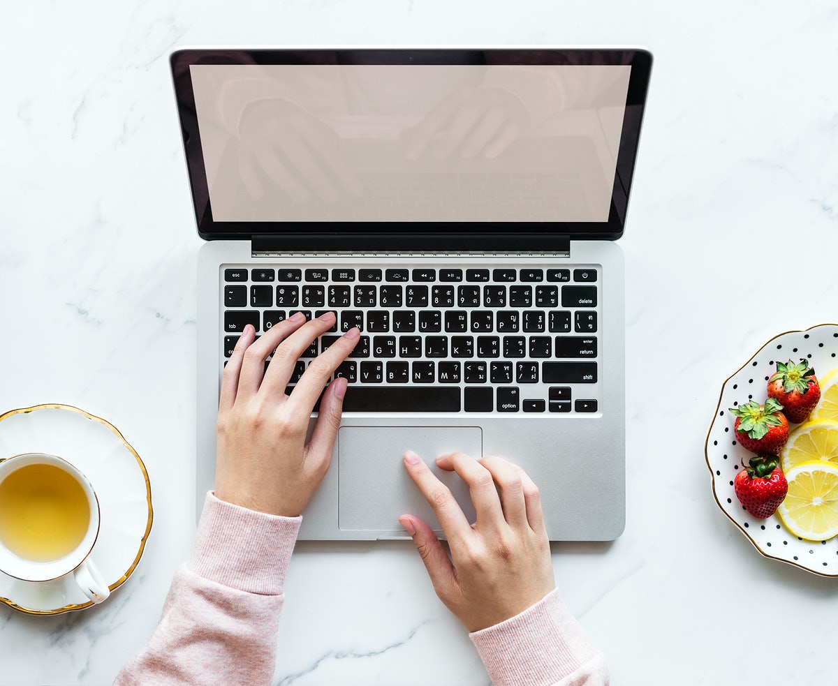 Free Aerial View Of Woman Using A Laptop