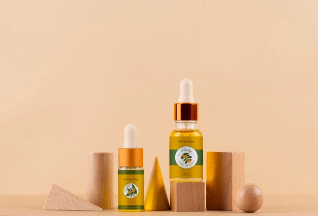 Free Argan Oil Cosmetic Bottle Mock-Up With Wooden-Shaped Podium And Kernels Psd