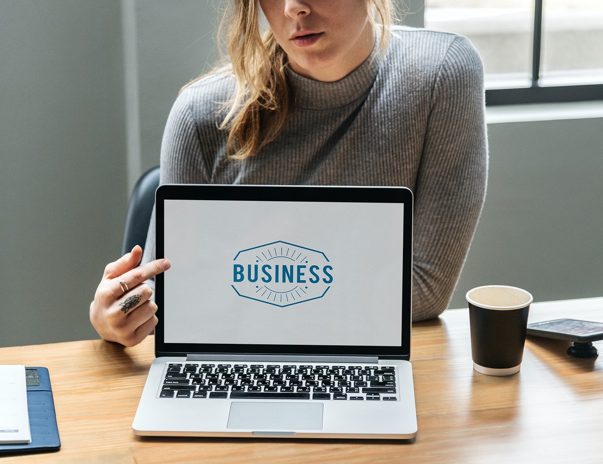 Free Blond Woman Pointing At A Laptop Screen