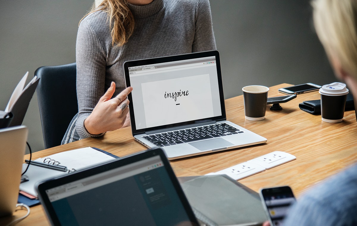 Free Blond Woman Pointing At A Laptop Screen