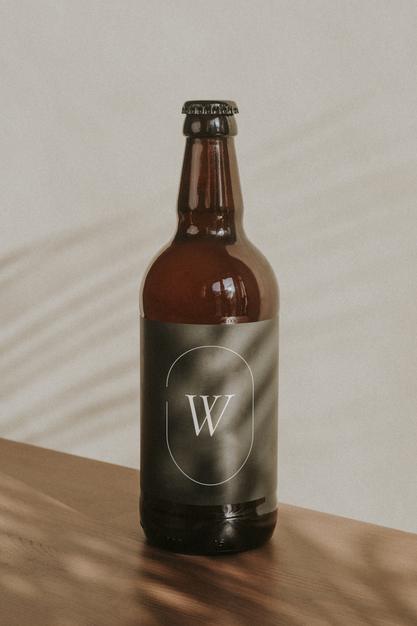 Free Brown Beer Bottle Mockup On Wooden Surface Psd