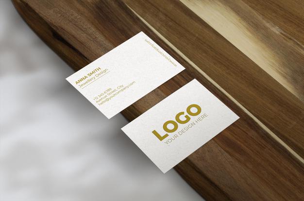 Free Business Cards Over Wood Surface Mockup Psd