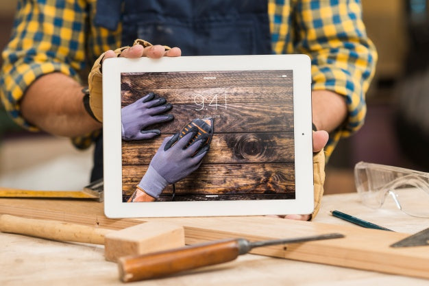 Free Carpenter Holding Tablet Mockup Psd