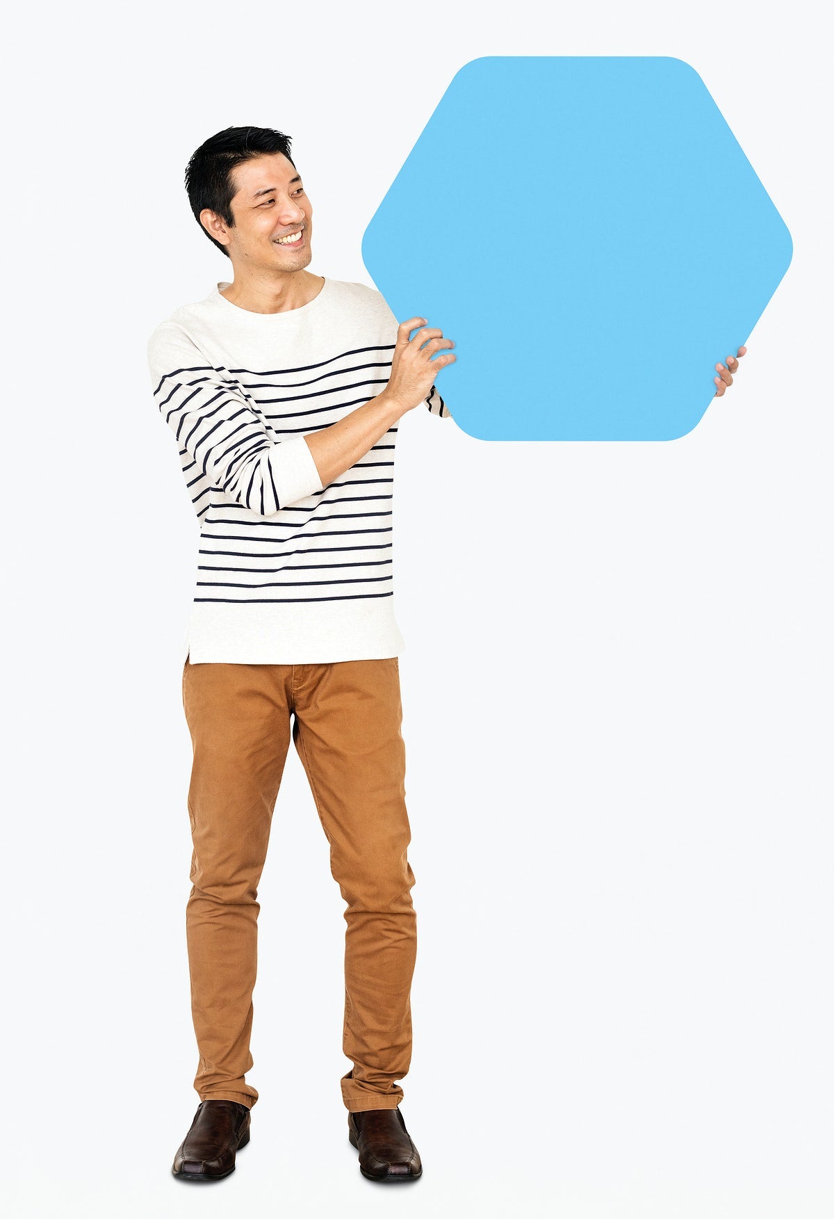 Free Cheerful Man Showing A Blank Blue Hexagon Board