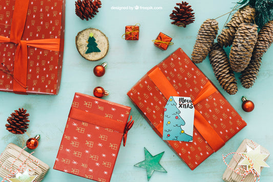 Free Christmas Mockup With Present Boxes And Pine Cones Psd